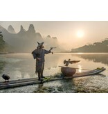 Smokes a pipe at the Li River