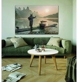 Smokes a pipe at the Li River