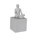Man meditating sitting on cube Man meditating sitting on cube