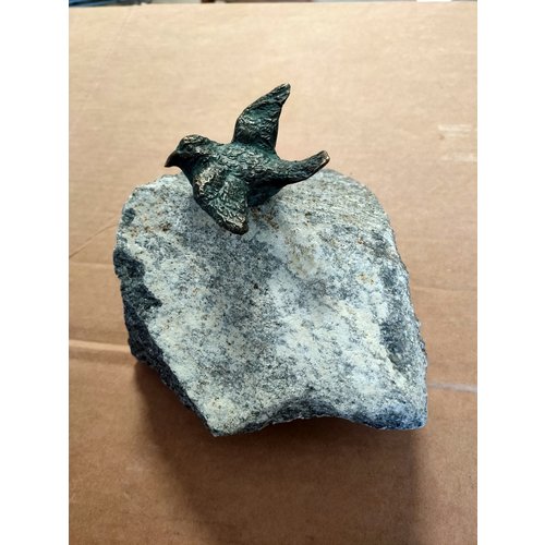 Bronze bird spread wings on stone Bronze bird spread wings on stone