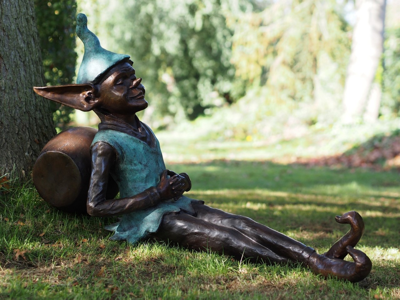 Bronze sculpture Pixie sitting next to a pot Eliassen Home & Garden