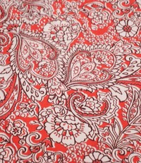  Polyester tricot koraalroze met wit paisley bloemen