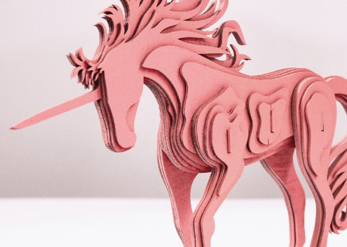 Pink laser cut unicorn assembled in layers to form a 3D figure using FLUX Beam Studio.