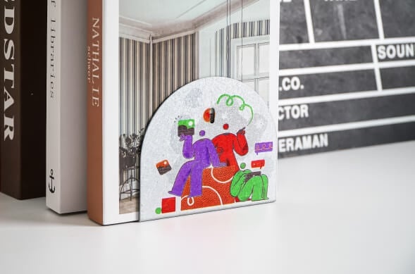 Aluminium bookmark printed with a colourful design of three people reading.