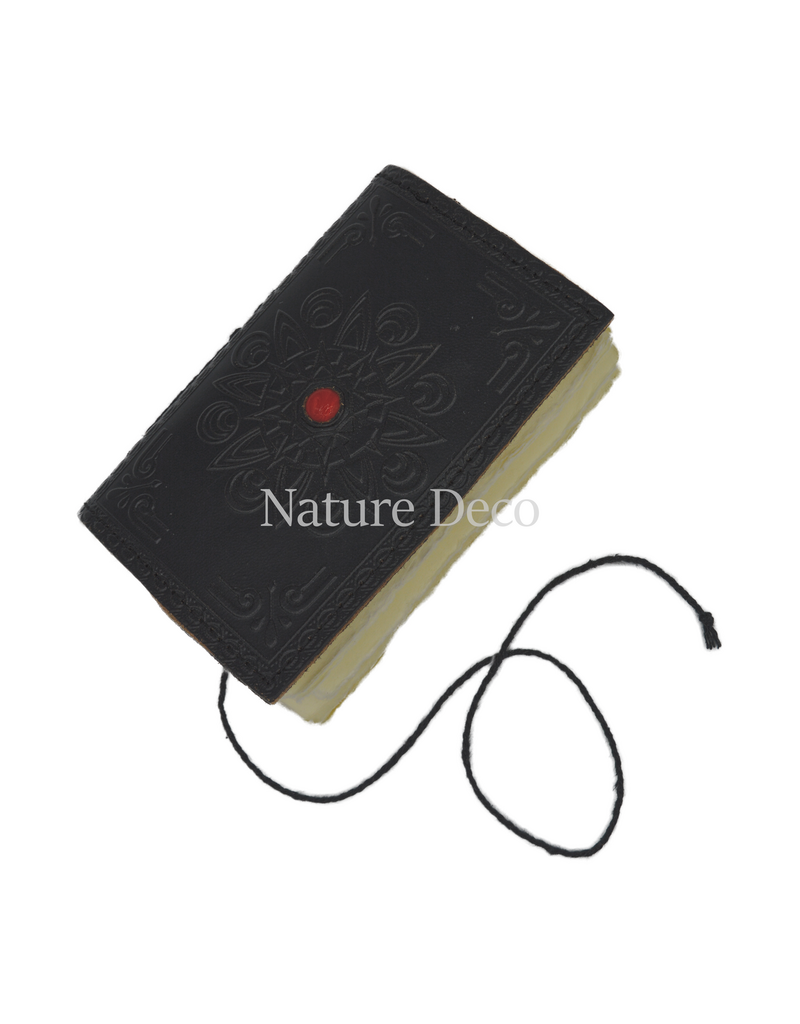 . Colored leather notebook with a stone