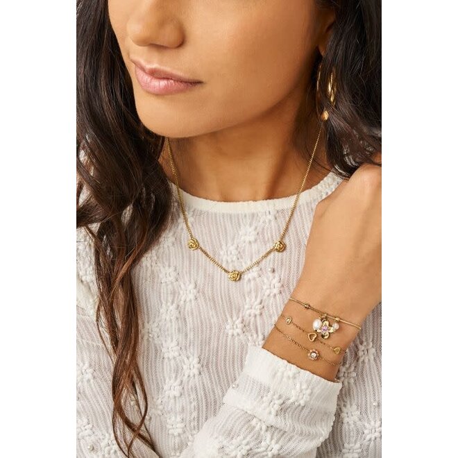 Botanical armband met bloem en roze strass steen goudkleurig