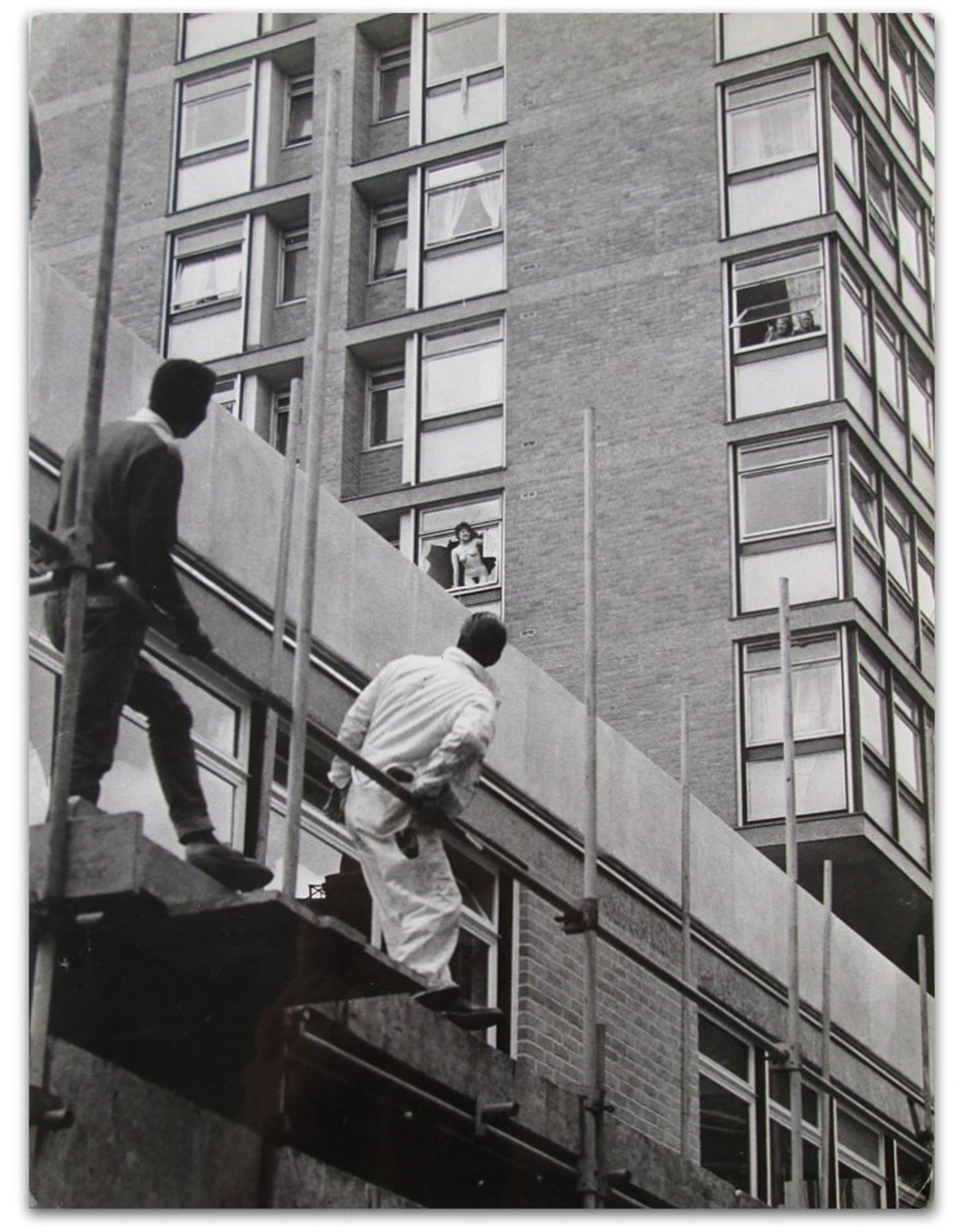 Maurice Hogenboom - Female streaker poses in broken window frame of Amsterdam apartment