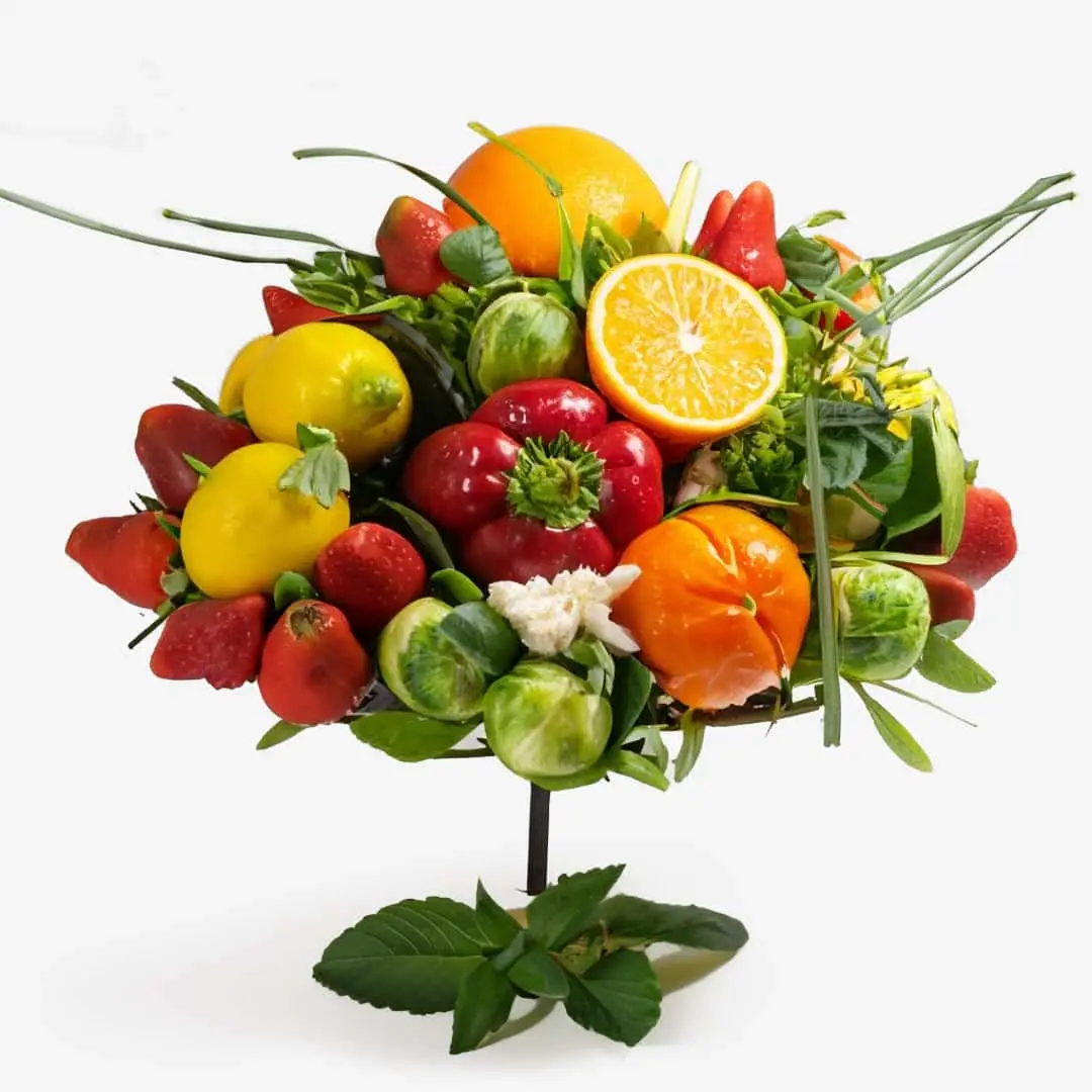 Ikebana arrangement featuring Reviving Vitamin C Face Serum with Hyaluronates and Calendula