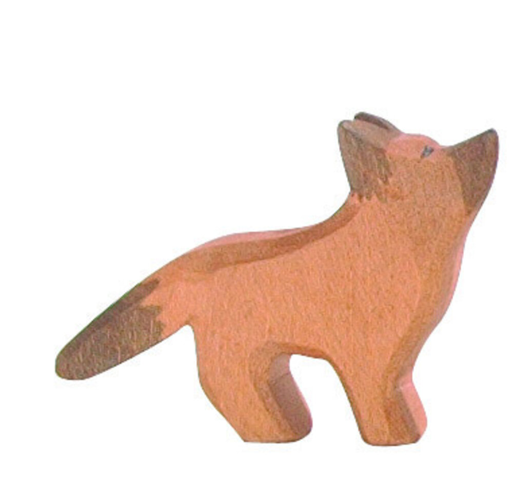 Baxter - Een klene zwarte en wtte hond de n het zand lgt