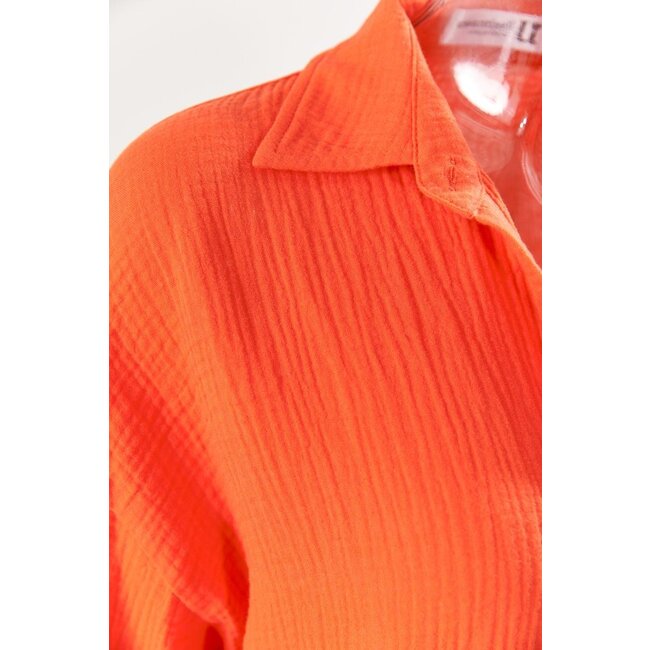 Orangefarbene Musselinbluse mit Trompetenärmeln