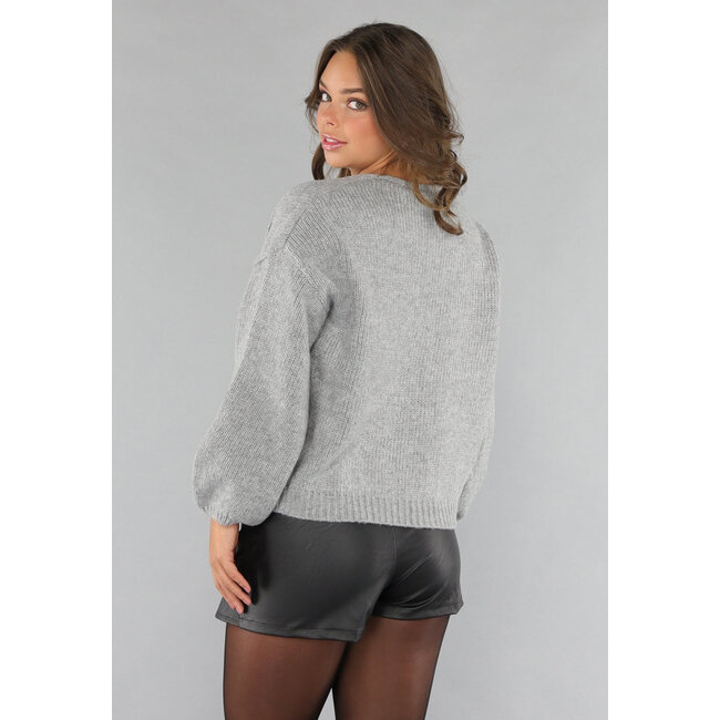 Grauer Pullover mit Pailletten-Schleifen
