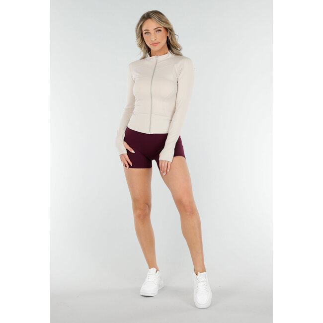 Taillierte beigefarbene Stretch-Sportstrickjacke mit Daumenlöchern und Stehkragen