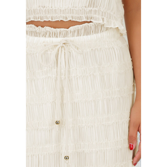 Zweiteiliges cremefarbenes Stretch-Set mit plissiertem Croptop und hochtailliertem Maxirock