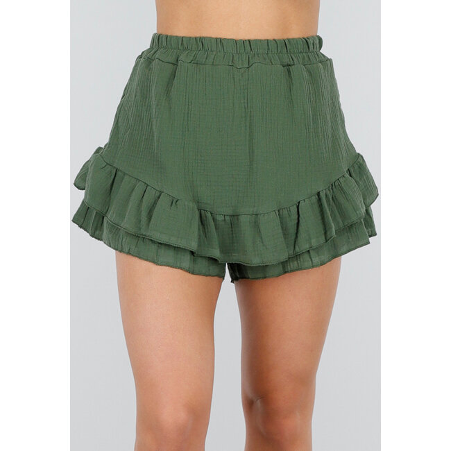 Grüner Baumwollskort mit Rüschen und Leinenoptik
