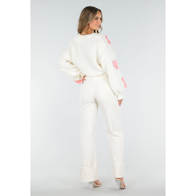 Gestrickte Strickjacke in Creme mit rosa Schleifen