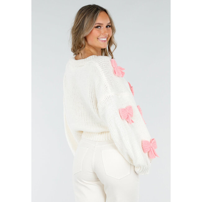 Gestrickte Strickjacke in Creme mit rosa Schleifen