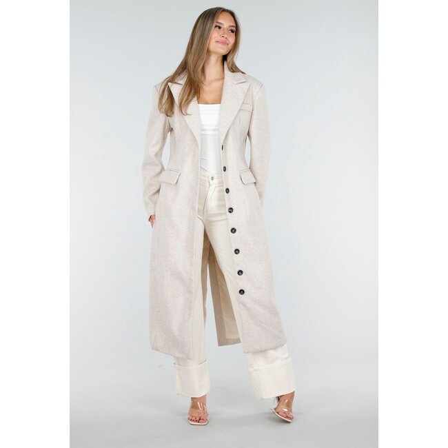 Langer beiger Mantel mit schwarzen Knöpfen und Pattentaschen