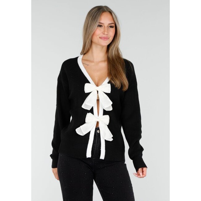 Schwarze Strickjacke mit weißer Schleifenverschluss und langen Ärmeln