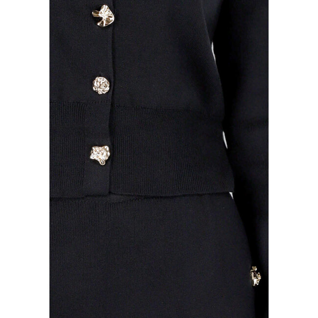 Schwarzes Strick-Set mit Midirock mit Schlitz