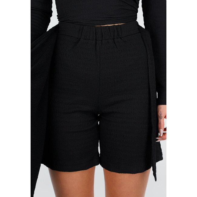 Schwarzer Stretch-Skort mit Schleifenverschluss und leicht strukturiertem Material