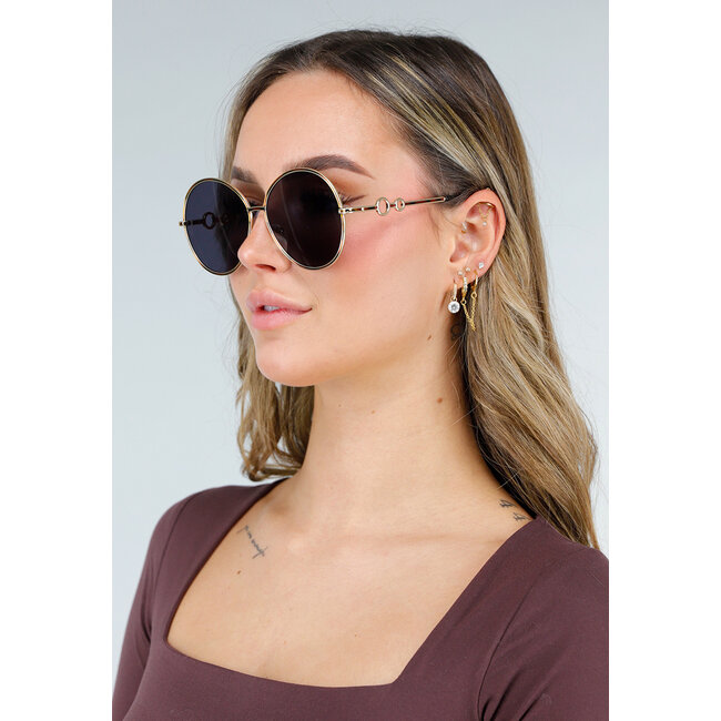 Goldfarbene runde Sonnenbrille mit dunklen Gläsern