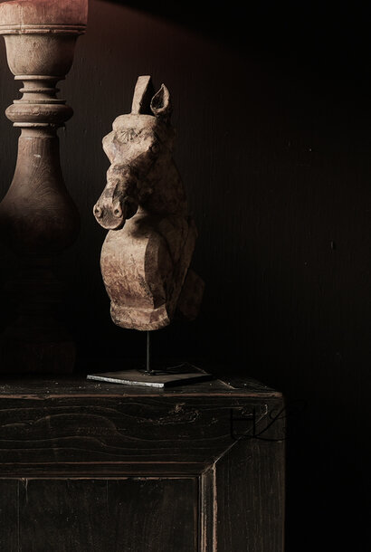 Unique authentic old wooden horse on an iron tripod