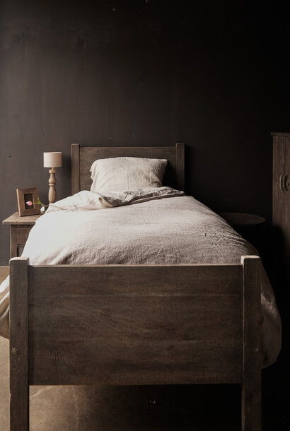 Tough single bed made of old used wood