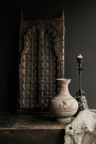 Ceramic vase with worn painting