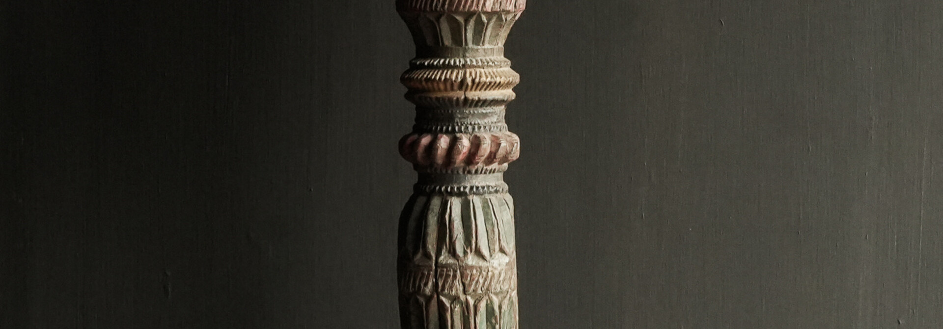 Uniquely colored Old Wooden Baluster on an iron base