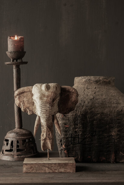 Wooden elephant head on an iron stand