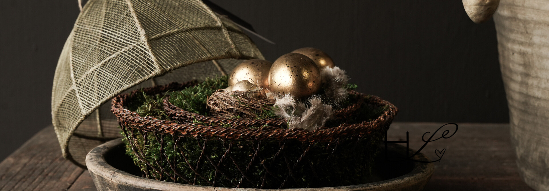 Bird's nests and gold-colored eggs packed in a box