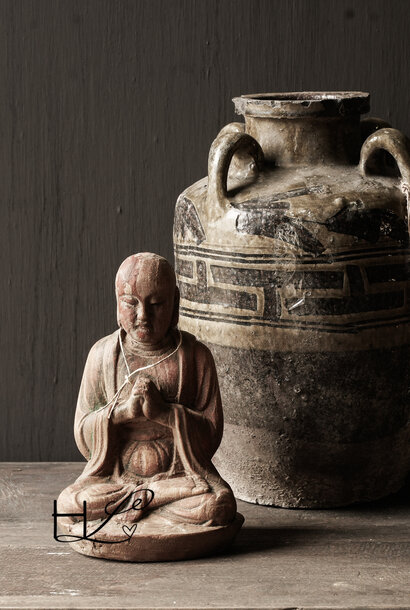 small wooden monk statue