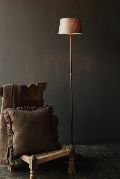 brown iron floor lamp on a round iron base
