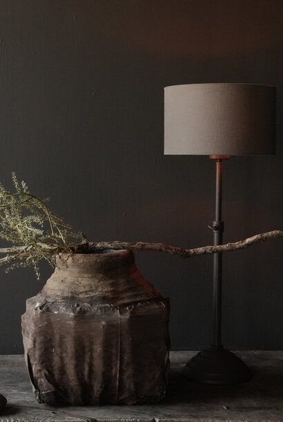 brown iron table lamp on round iron base