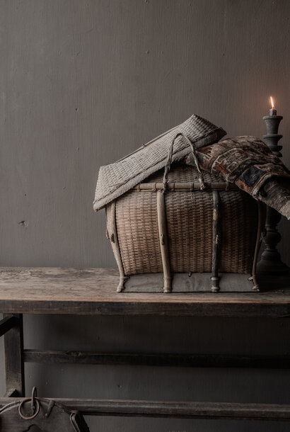 Old authentic wicker transport basket with lid