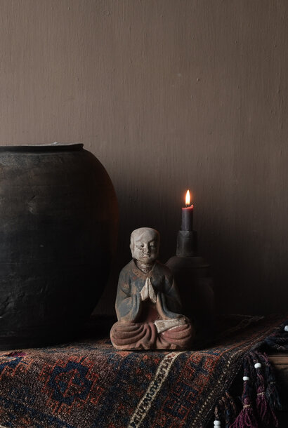 small wooden monk statue