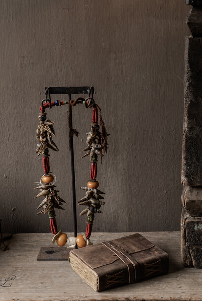Ethnic shell necklace with beads – decorative tribal necklace on a stand