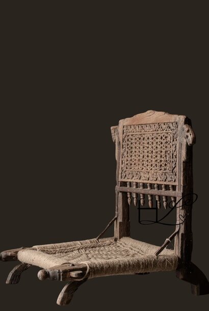 Unique antique low tribal chair with new seat