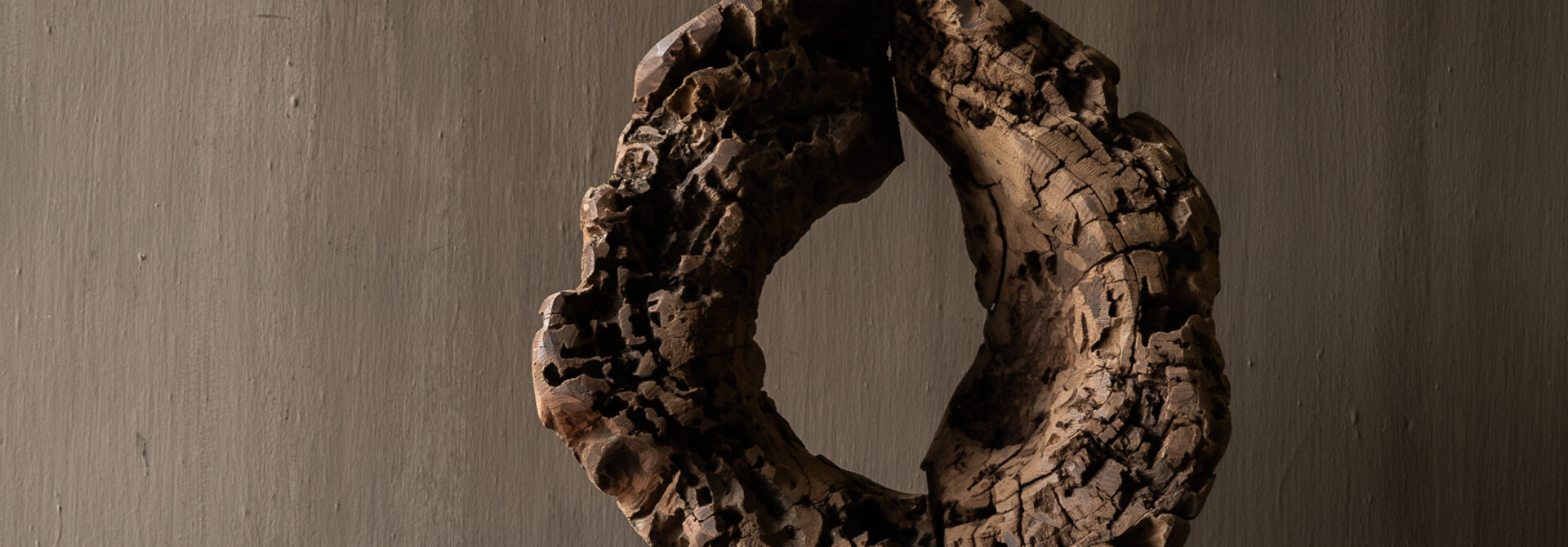Round wooden ornament made of old wood on a base