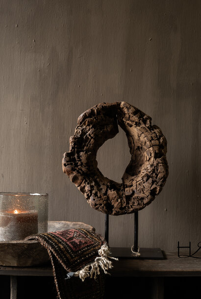Round wooden ornament made of old wood on a base