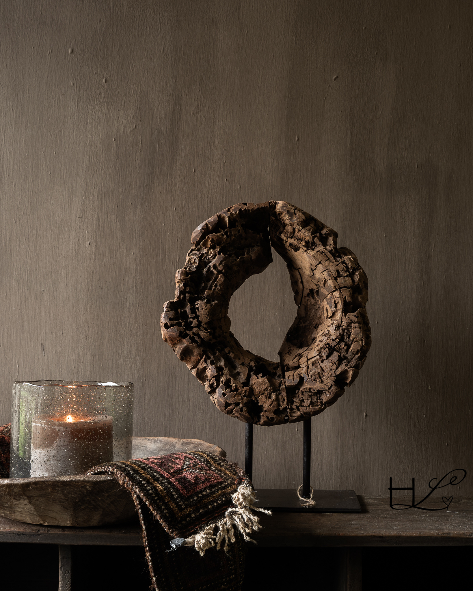 Round wooden ornament made of old wood on a base-1
