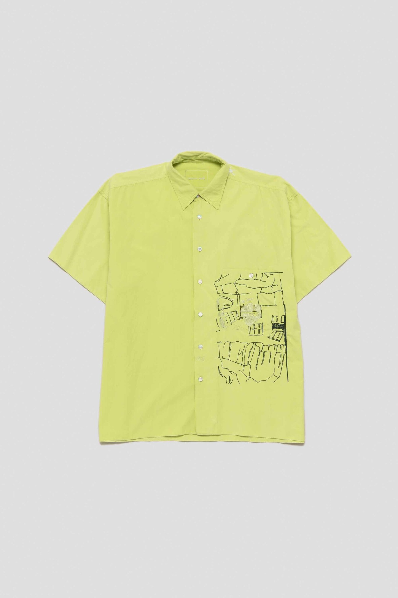 green shirt with rock house at sea