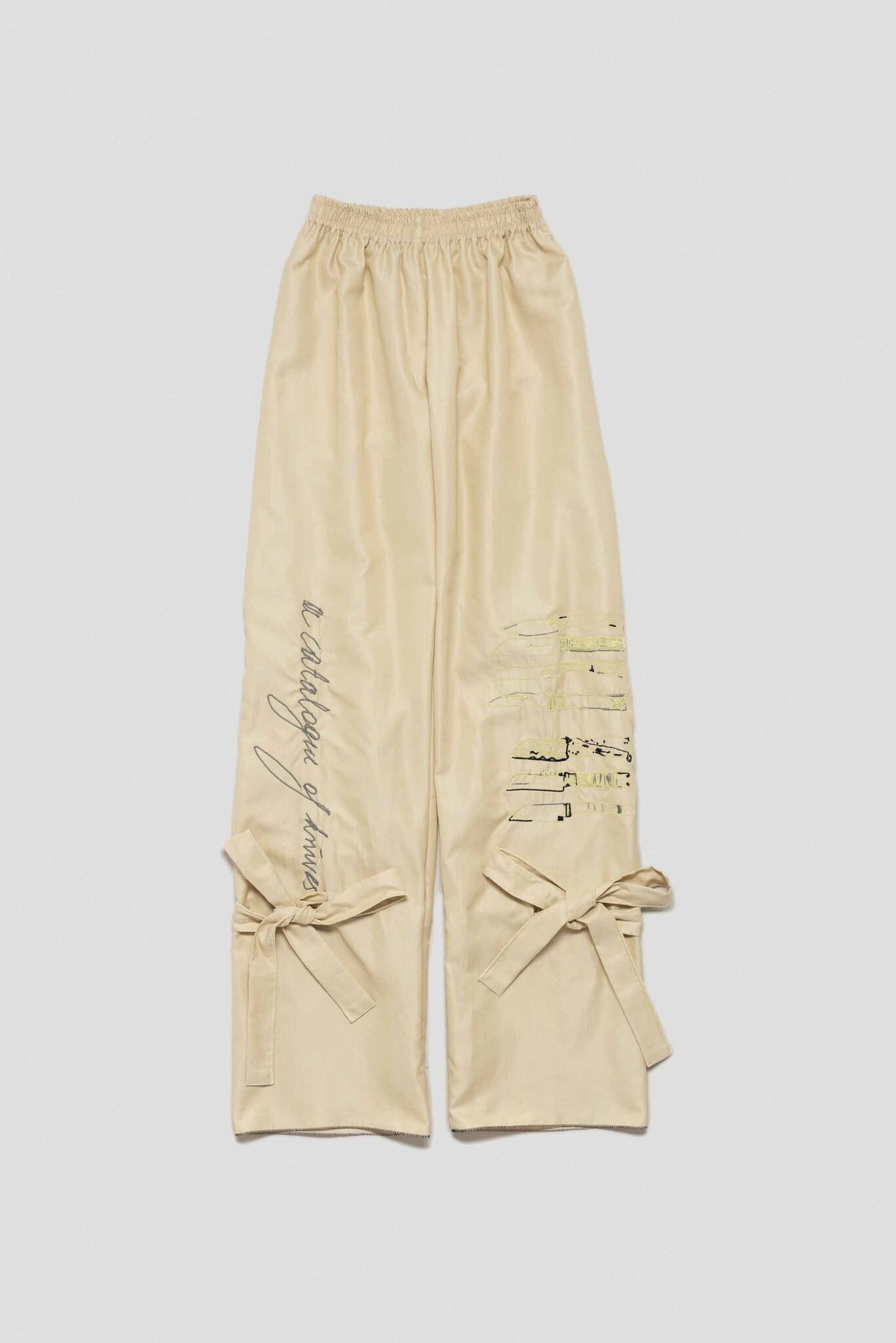 pale yellow trousers with catalogue of knives