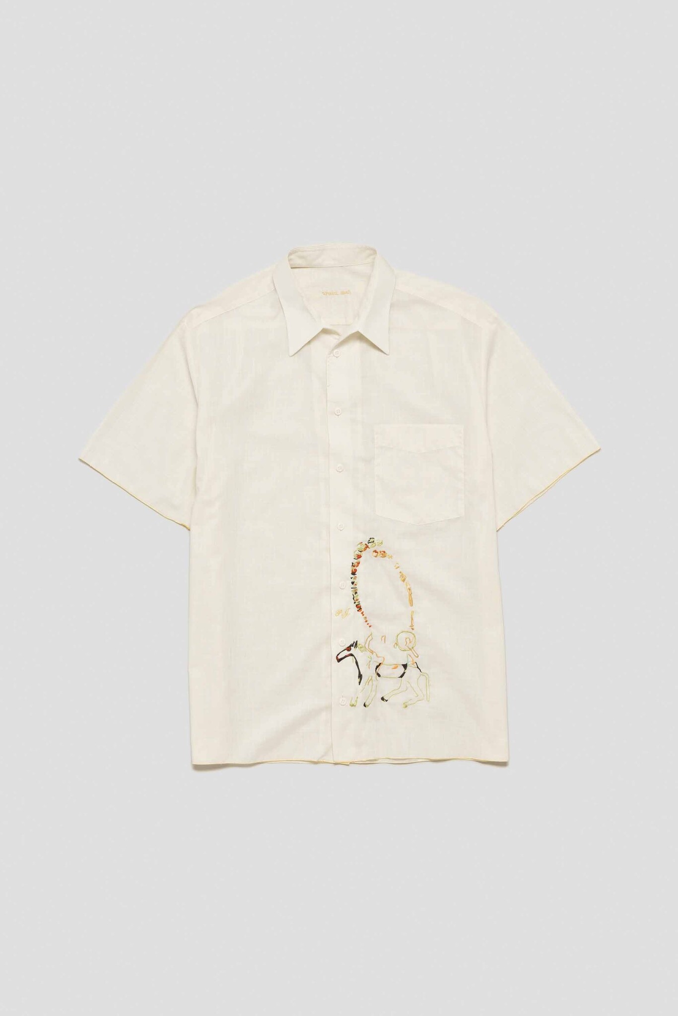white shirt with ancient horse ring