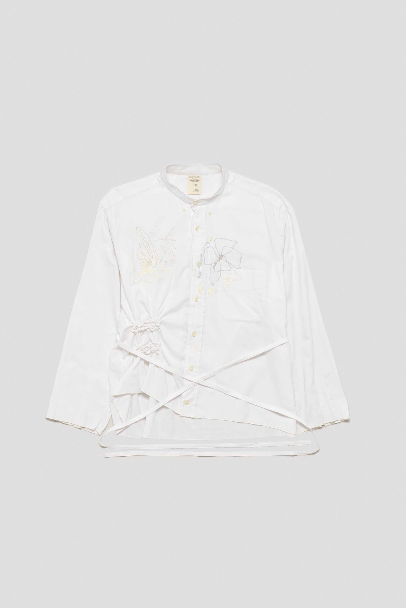 white shirt with fish, clover, cross