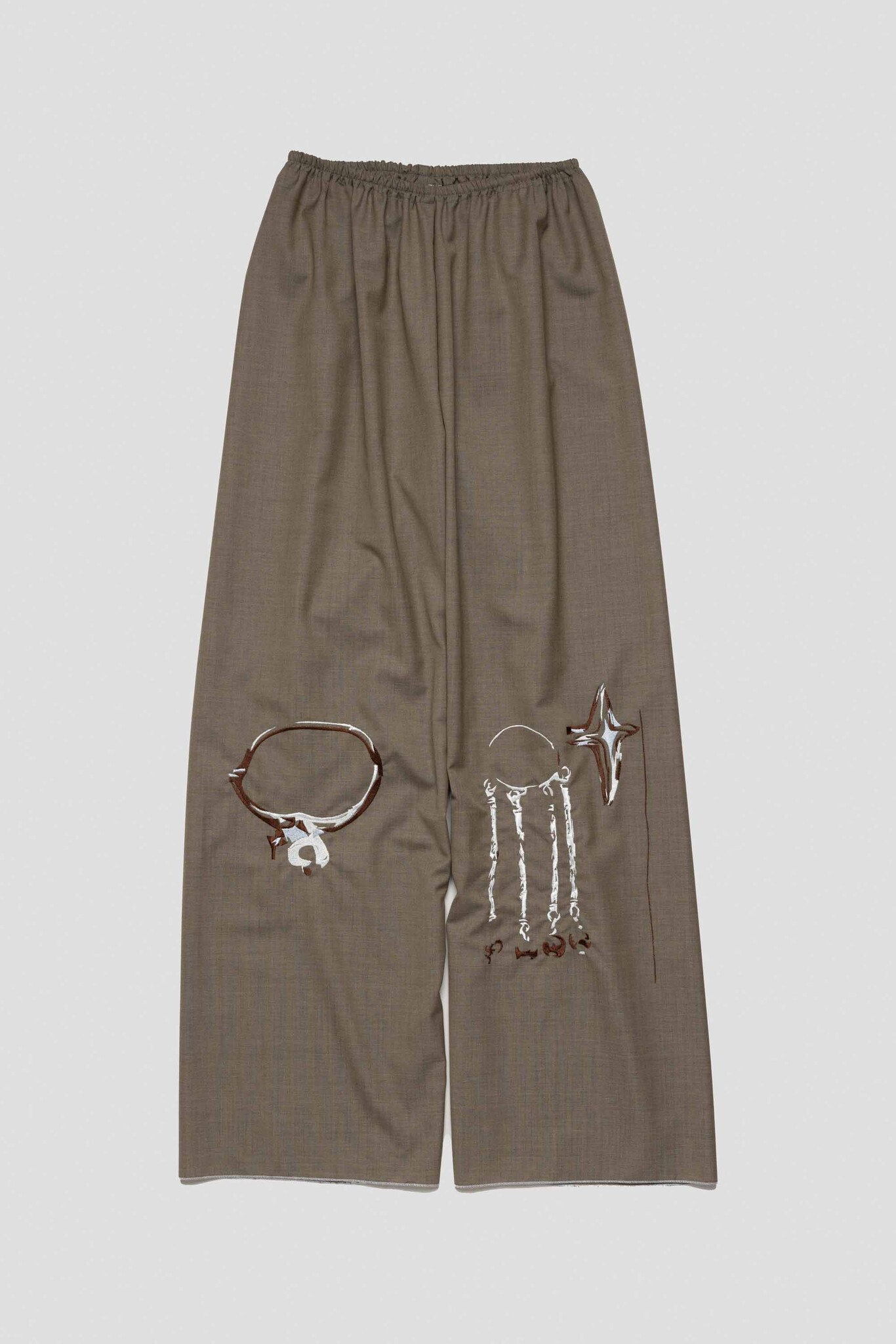 brown trousers with charm necklace