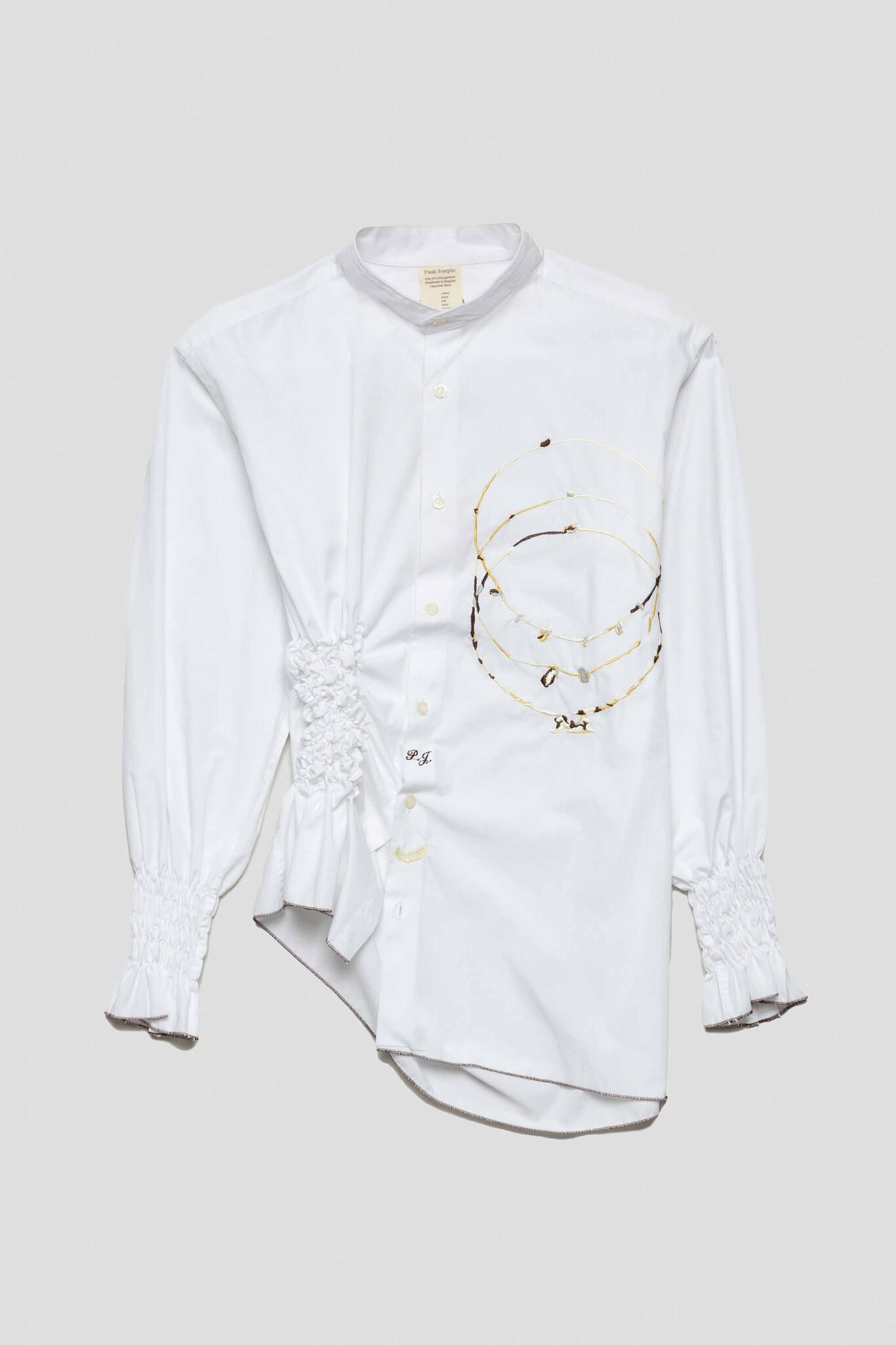 white shirt with three charm rings