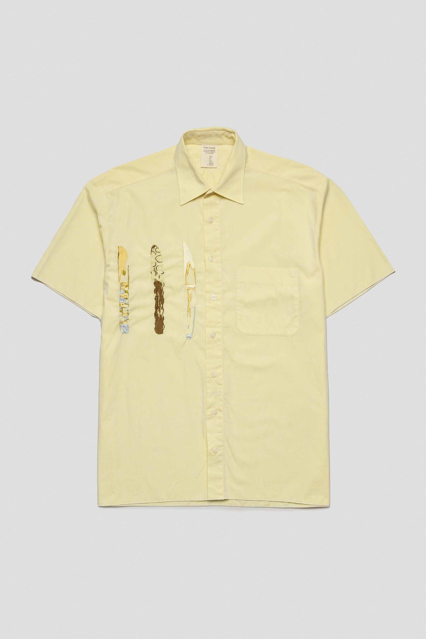 yellow shirt with three knives
