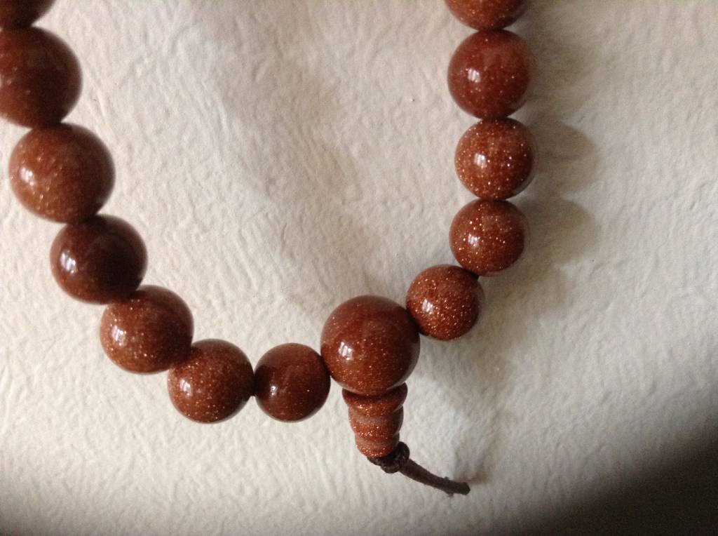 wearing buddhist prayer beads