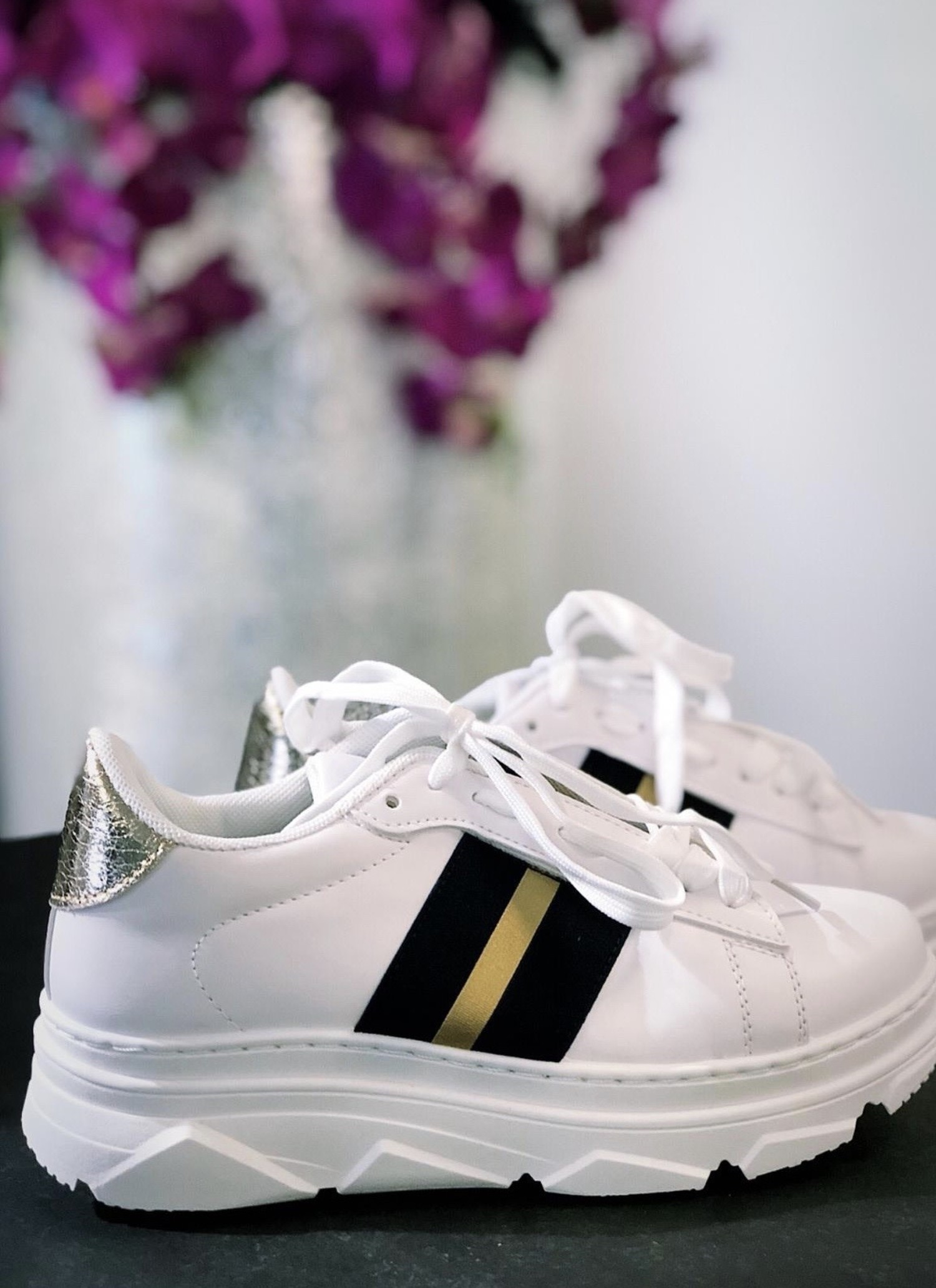 white tennis shoes with black stripes